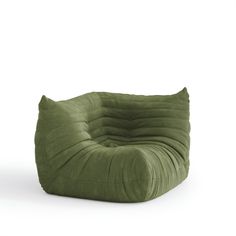 a green bean bag chair sitting on top of a white floor