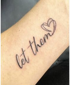 a tattoo with the word'let them'written in cursive writing on it