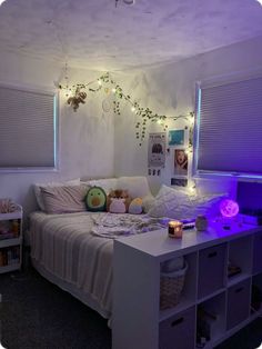 a bed room with a neatly made bed and purple lights on the wall above it