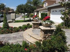 a house with landscaping and flowers in the front yard