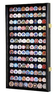 a display case filled with lots of different types of button badges on black canvases