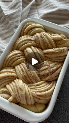 a white dish filled with sliced bananas on top of a table