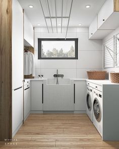 a washer and dryer in a small room with wood flooring on the walls