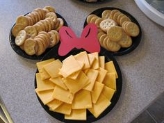 a mickey mouse plate with crackers and cheese