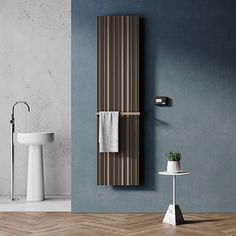 a bathroom with blue walls and wooden flooring next to a white sink, toilet and towel rack