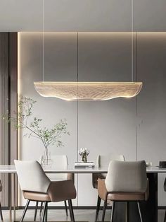 a modern dining room with white chairs and an oval light fixture hanging from the ceiling