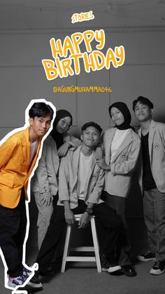 a man standing next to a group of people in front of a happy birthday sign