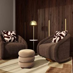 a living room with two brown chairs and a white ottoman in front of a wood paneled wall