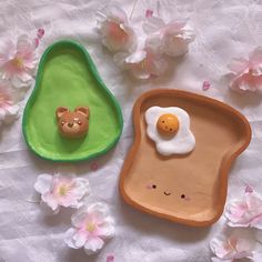 two pieces of bread with an egg in the shape of a bear and a teddy bear