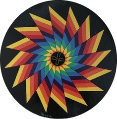 a multicolored circular design on a black background