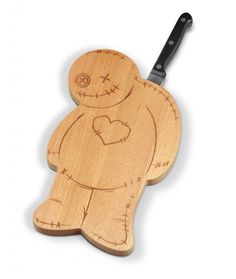 a wooden cutting board with a cut out of a teddy bear