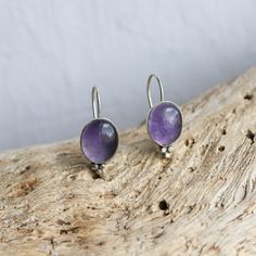 These are wonderful soft purple Amethyst drop earrings. The Lavender Amethyst color is perfect! This is the Piper Earring design -- new at LBJ -- but soon to be a favorite! And we couldn't love it more than here in this fabulous, soft purple Amethyst. Modern and traditional at the same time! Minimal embellishments except for the trio of sterling silver beads ... just enough to add mystique to these purple Amethyst drop earrings. All .925 Sterling Silver -- oxidized, sanded and burnished to the p Handmade Amethyst Purple Earrings, Round Amethyst Earrings With Natural Stones, Lavender Amethyst Earrings With Natural Stones, Purple Earrings With Natural Stones, Purple Natural Stones Round Earrings, Round Purple Earrings With Natural Stones, Lavender Amethyst Round Earrings, Nickel-free Lavender Amethyst Earrings, Nickel-free Amethyst Lavender Earrings