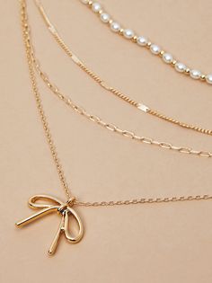 Add a dash of charm to your look with our super dainty and adorable necklace featuring a bow charm and delicate pearl detailing. This elegant accessory exudes timeless beauty, perfect for effortlessly elevating any ensemble with its whimsical and graceful allure. Preppy Christmas List, Preppy Christmas, 2024 Christmas, Bow Jewelry, Altard State, Accessories Jewelry Necklace, Elegant Accessories, Altar'd State, Sweater Sale