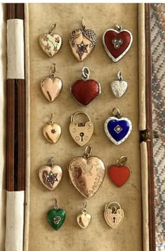 a box filled with lots of different colored heart shaped charms on top of a table