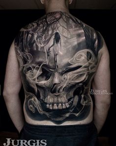 the back of a man with a skull tattoo