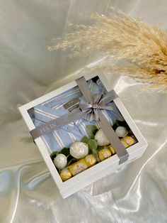 a white box filled with different types of chocolates