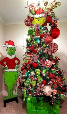 the grinch christmas tree is decorated with candy canes