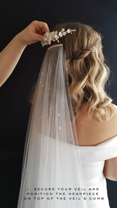 the back of a bride's wedding veil with flowers on it