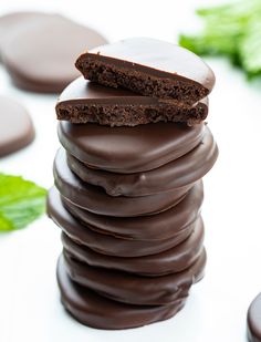 there are chocolate dipped wafers stacked on top of each other with the words, copycat thin mints