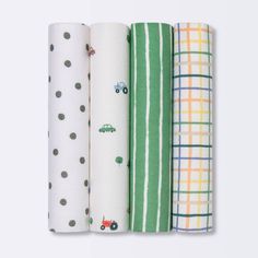 four different types of baby swaddles lined up in a row on a white background