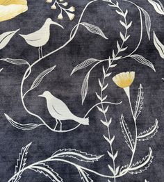 an area rug with yellow flowers and birds on black groundcloth, close up view