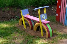 a colorful wooden bench sitting in the grass