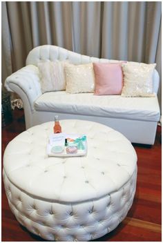 a white couch and ottoman in a room