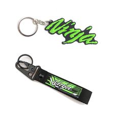 two key chains with green and black letters on them, one has a lanyard