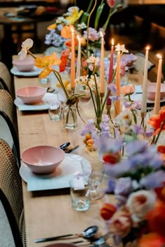 a long table is set with flowers and candles for a formal dinner or party event