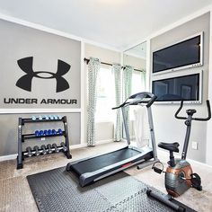 an exercise room with treadmill and television