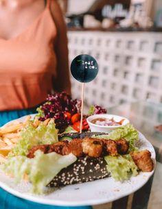 a woman is holding a plate with food on it