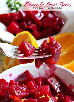 there is a fork in a bowl with beets and oranges on the side