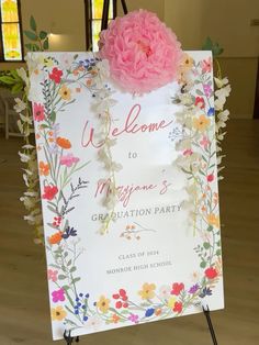 a welcome sign with flowers on it