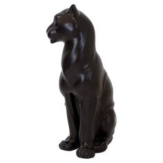 a black cat statue sitting on top of a white floor