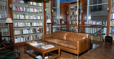 a living room filled with furniture and lots of books