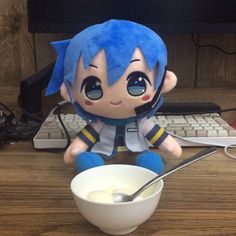 a stuffed toy sitting next to a bowl of cereal