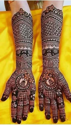 two hands with henna designs on them