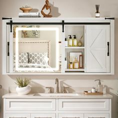 a bathroom vanity with white cabinets and drawers