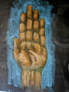 a chalk drawing of a hand on a blackboard