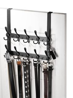 a coat rack with several pairs of belts hanging on it