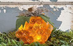 a pumpkin made out of glass sitting in the grass