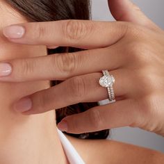 a woman's hand with a diamond ring on her finger