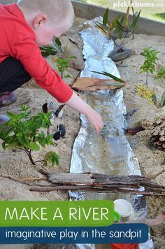 a young boy is playing in the sand near a small stream and plants with text overlay that reads make a river imaginative play in the sandpit