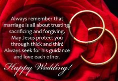 two wedding rings sitting on top of a red rose with the words happy wedding written below it