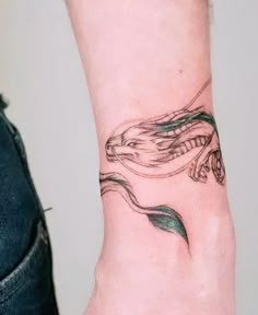 a woman's wrist with a tattoo design on the left side of her arm