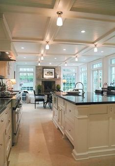 a large kitchen with an island in the middle and lots of counter space on both sides