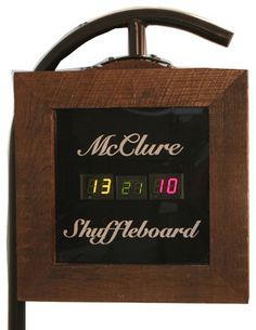 a wooden clock with the time displayed on it's display stand, in front of a white background