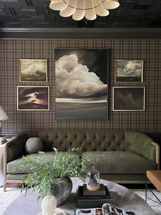 a living room filled with furniture and pictures on the wall above it's coffee table