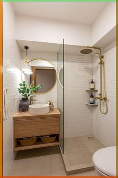 a bathroom with a sink, mirror and shower stall in the corner next to a toilet