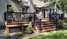 a house with stairs leading up to the front door and side porchs on both sides